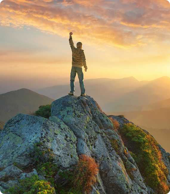 Hiker celebrates atop a scenic mountain