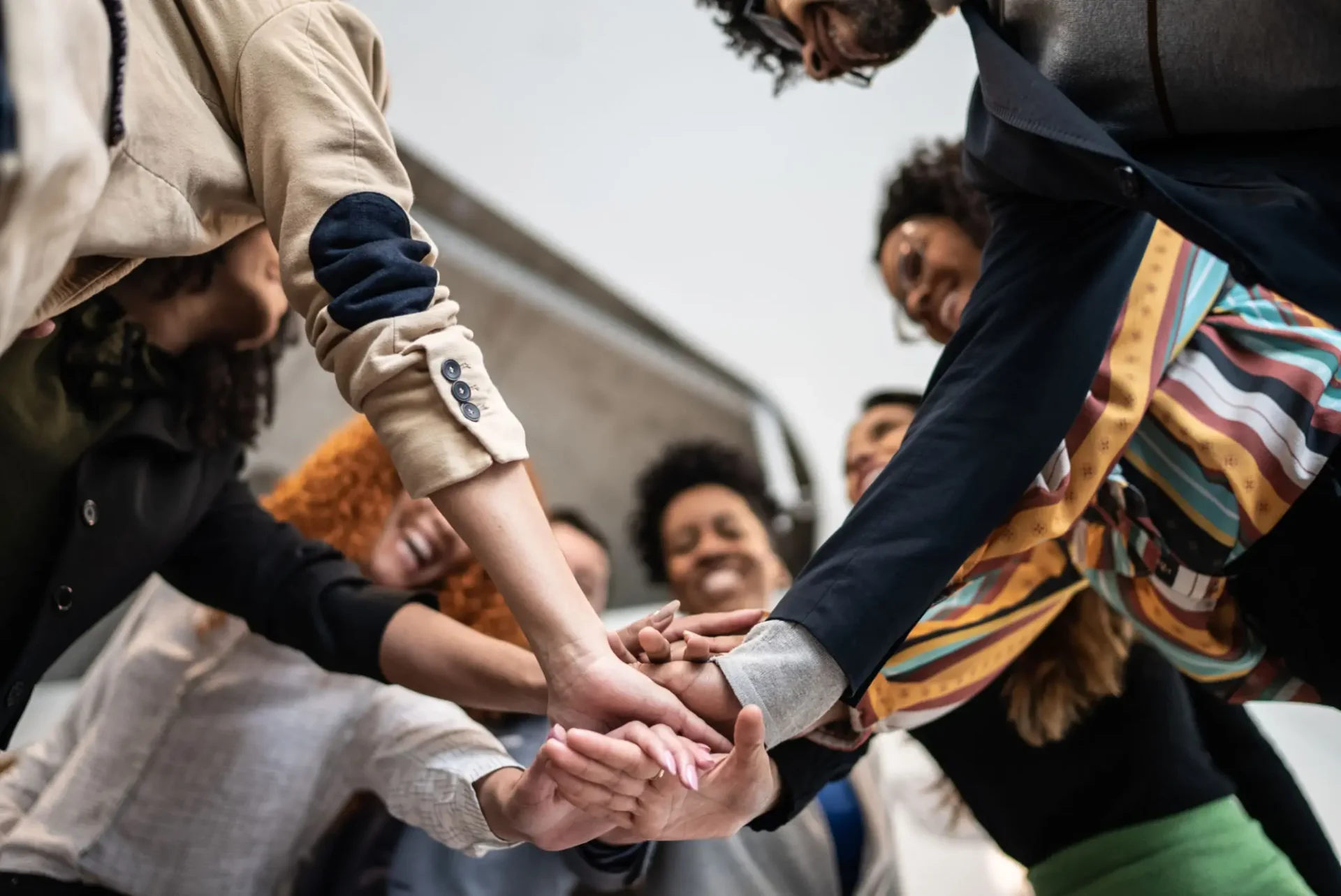 Team joining hands in unity