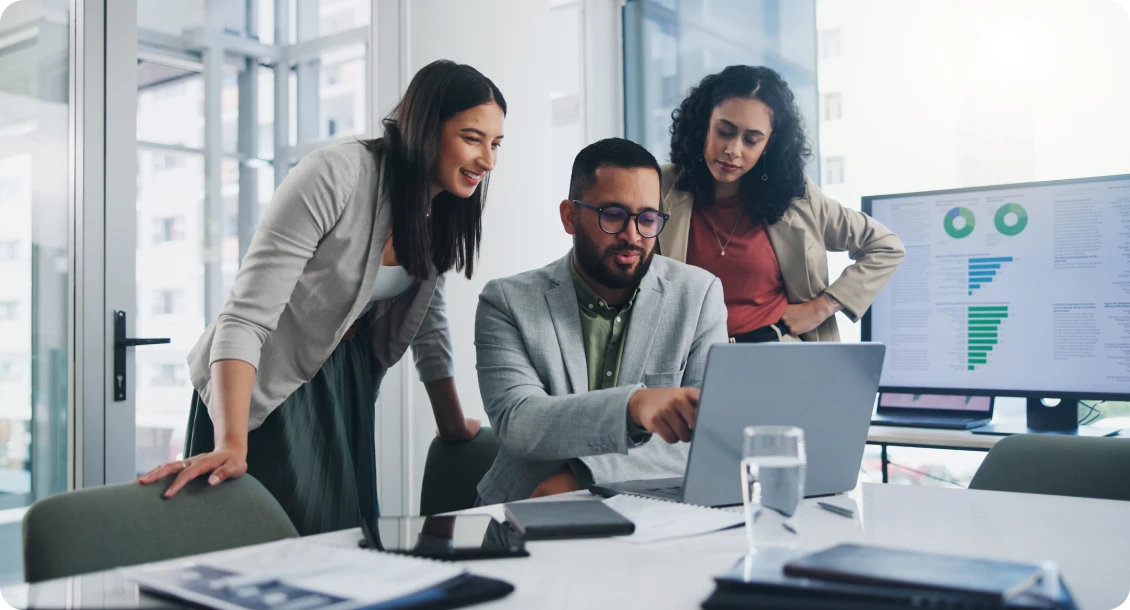 Team discussing work on a laptop